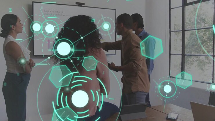 Curly-haired woman facing screen while man tapping tablet and pointing, HUD animating for business