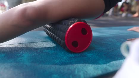 woman performing foam rolling on leg