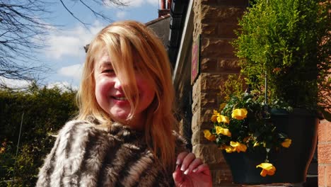 happy woman enjoying basket of flowers in garden medium portrait zoom shot slow motion portrait