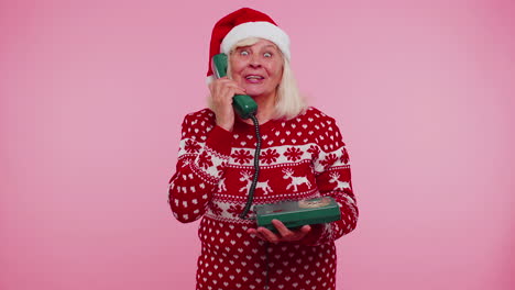 Mature-Christmas-grandmother-woman-talking-on-wired-vintage-telephone-of-80s,-hey-you-call-me-back