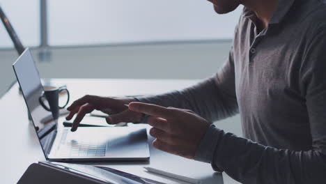 Businessman-Working-Late-On-Laptop-At-Desk-In-Office-Making-Online-Payment-With-Credit-Card