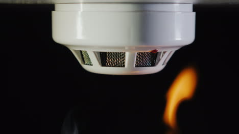 the smoke detector is triggered by a fire smoke and flames are visible 4k video