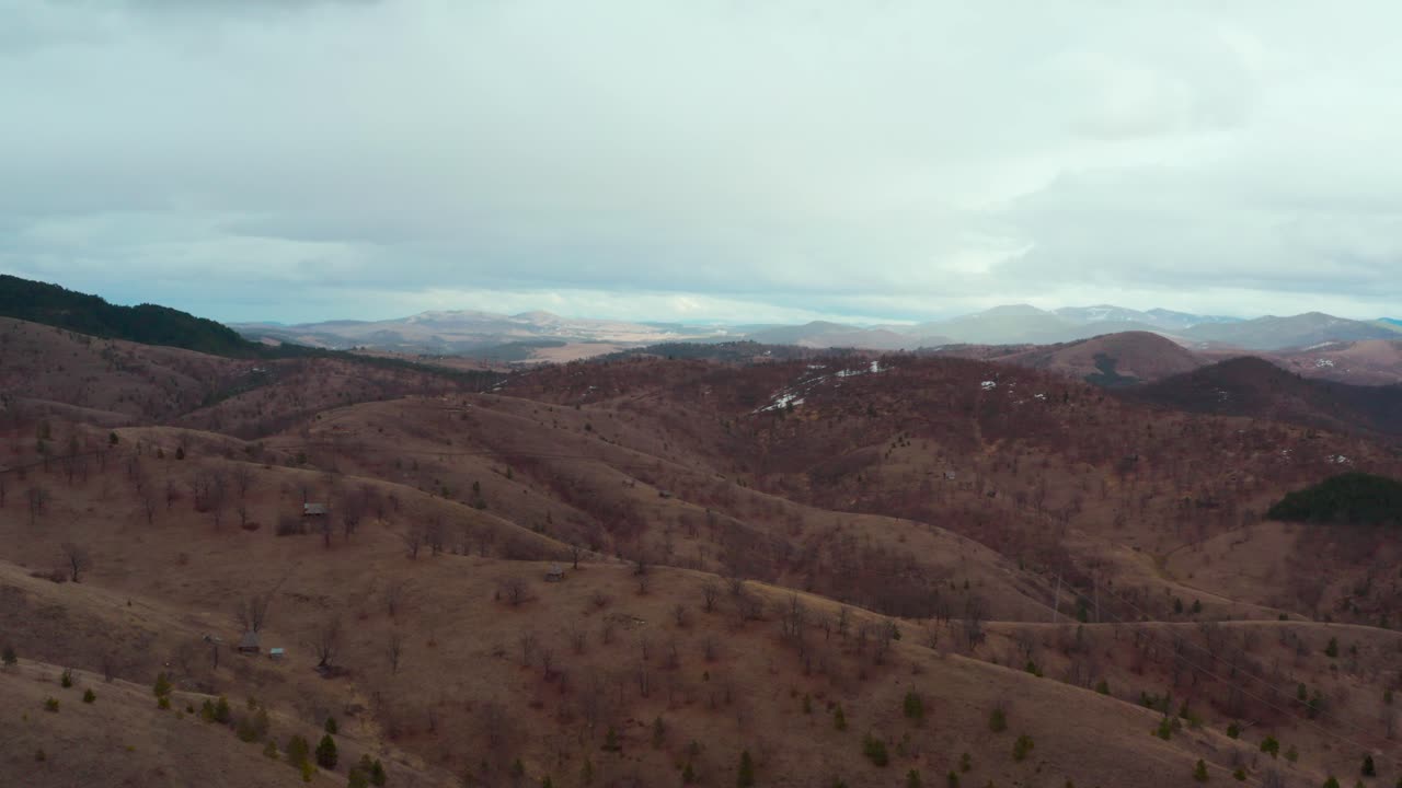 Landscape View Of Curved Forestry Terrain With Mountain Slopes Under Cloudy Sky. - Aerial Shot