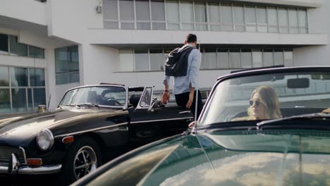 friends gathering at vintage car
