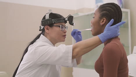 female doctor does a medical check up in a patient's mouth, a young girl 1