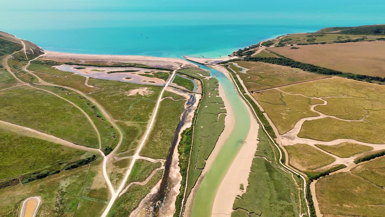 Aerial view of Cuckmere Haven, Sussex - where the meandering River Cuckmere meets the English Channel by the Seven Sisters cliffs. Stunning floodplains, oxbow lakes, and coastal beauty