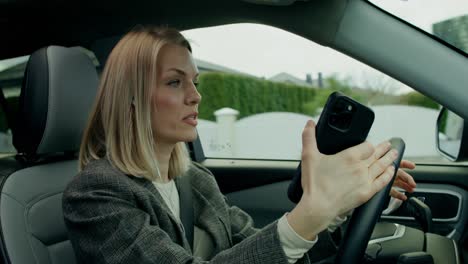 woman driving and using smartphone