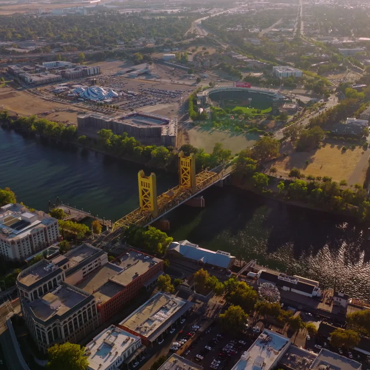 Amazing Sacramento on beautiful sunny daytime. Sacramento River crossing the lively urban city. Aerial view