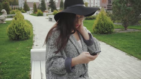 woman in a park using smartphone