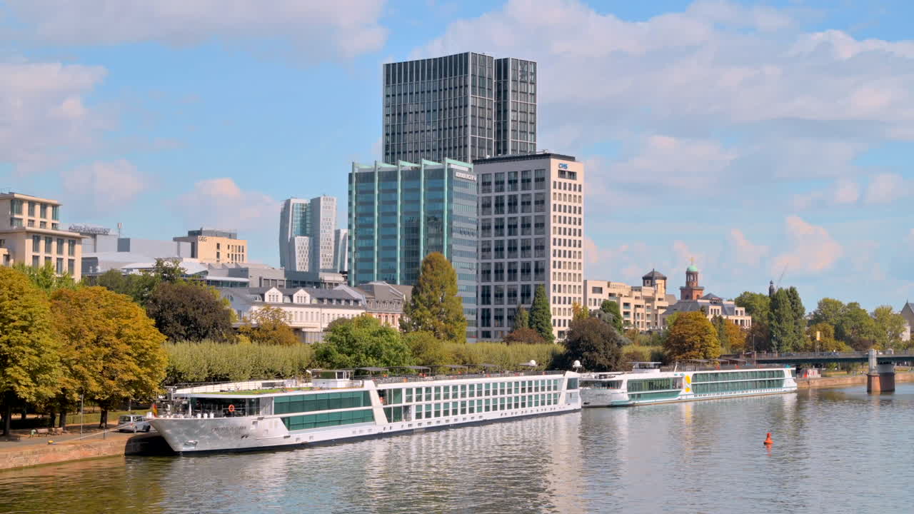 Frankfurt, Germany - November 13, 2022: White ship docked on the Main river in daylight