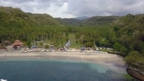 Buttery-soft-aerial-view-flight-panorama-overview-drone-shot-of-perfect-Crystal-Bay-Beach-with-turquoise-water