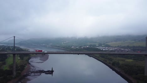 Trucks-Driving-over-Erskine-Bridge-on-River-Clyde-in-Scotland,-Gateway-to-the-Highlands---Aerial-Drone-4K-HD-Footage,-Fly-Right