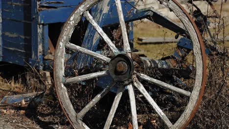 old patinaed and rusting wooden farm wagon wheel