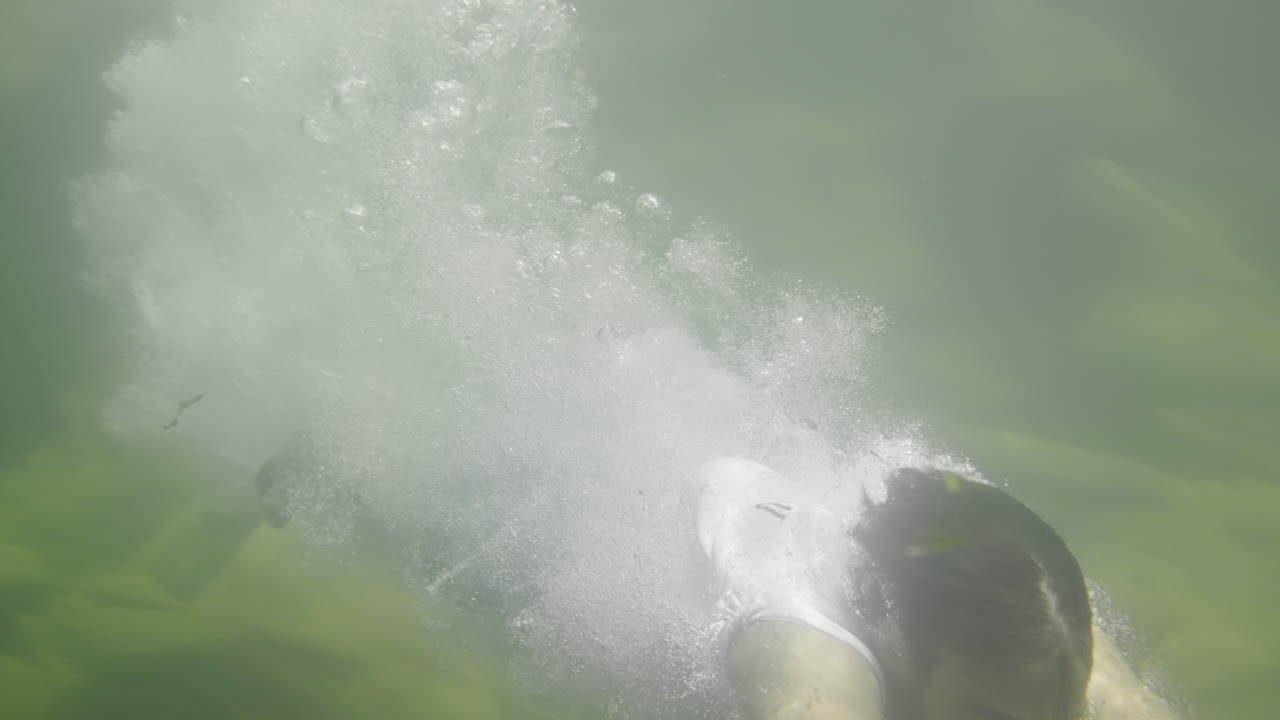 Person Diving into a Cave River