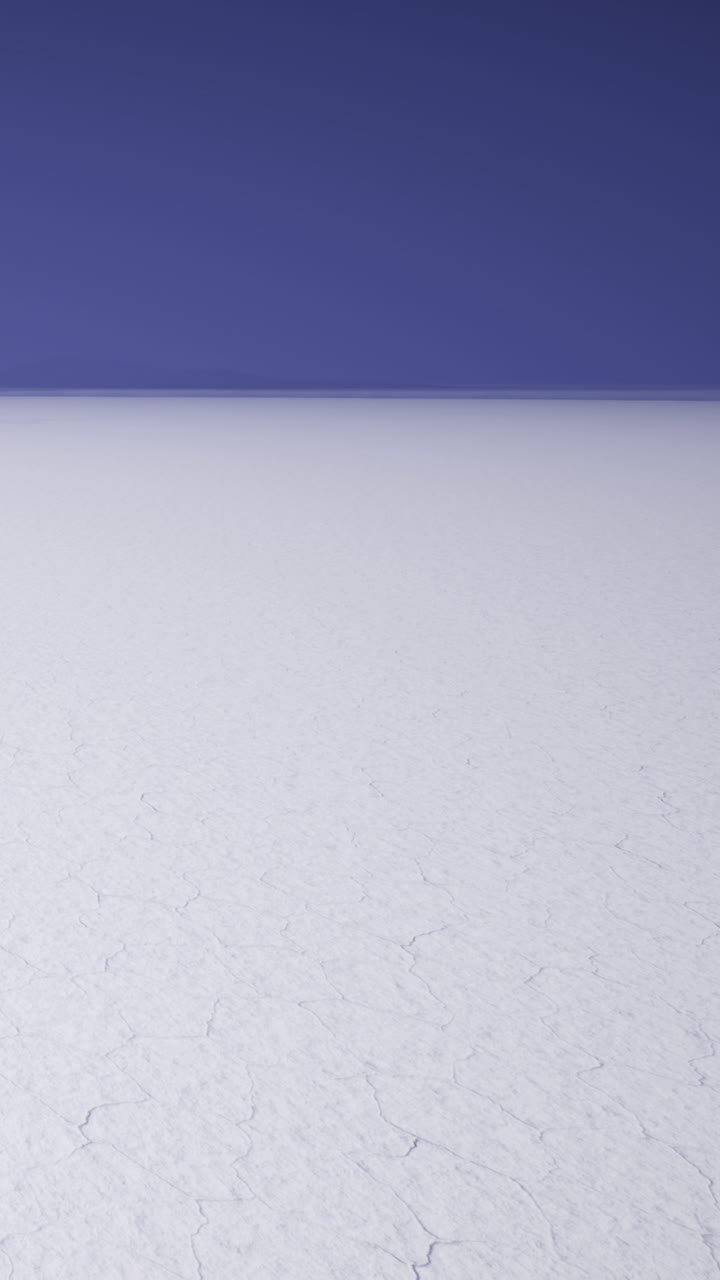 Salt flat stretches under a clear blue sky in a remote location