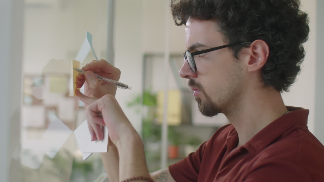 Man Working with Sticky Notes in Office