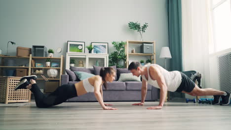 couple doing push-ups at home