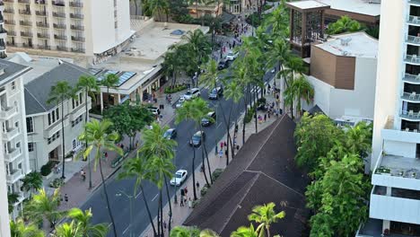 view looking down on kalakaua avenue in waikiki during the evening