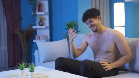 young man being pleasant and cheerful at night at home.