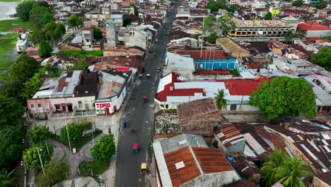 aerial drone fly view of moto taxi tuk tuk tuks and heavy traffic close to belen market in iquitos, peru, south america