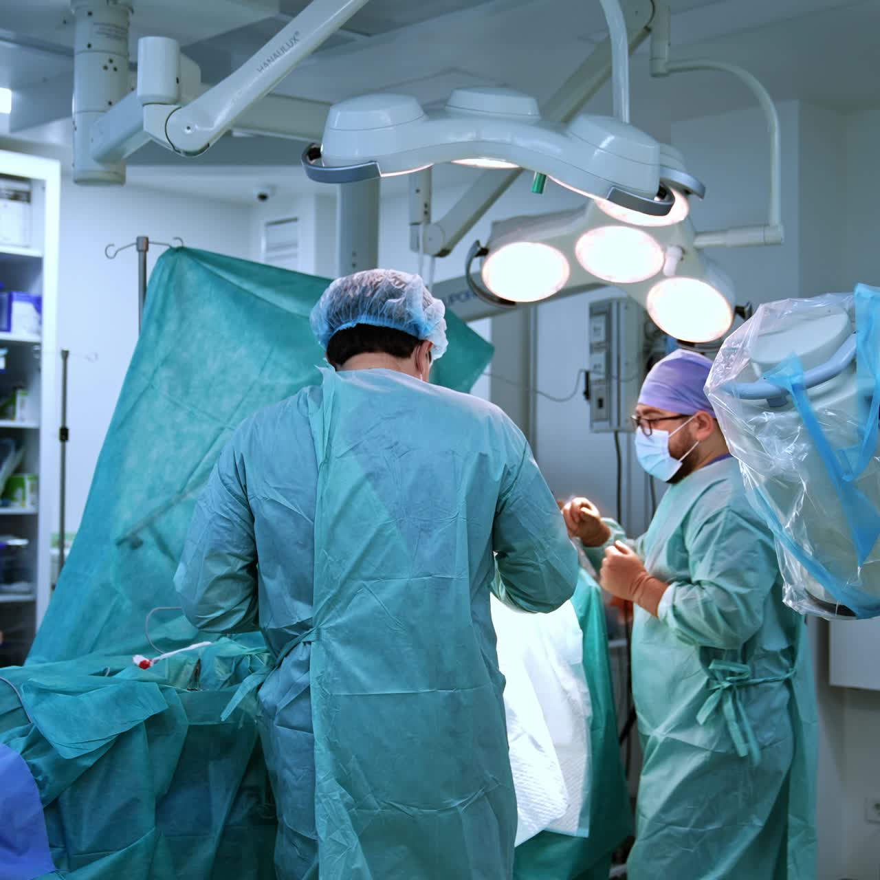 Modern operating room. Team of professional surgeons working in hospital ward