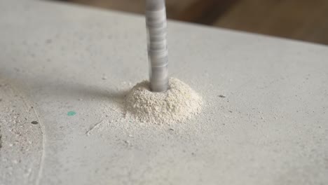 pile of shavings surrounding a metal drill