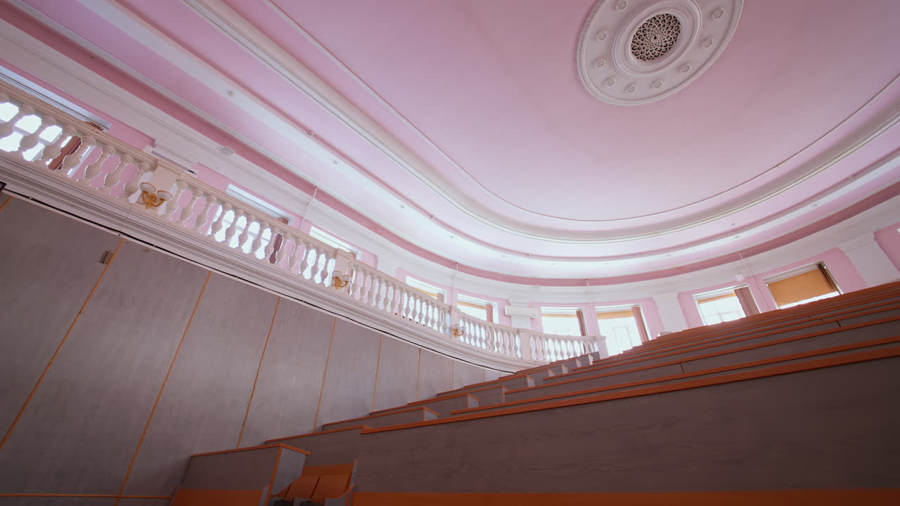 University lecture room without student. Empty university classroom with wooden chairs and desks
