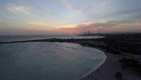 baby beach during a june sunset and people bathing in the sea, aruba