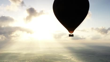 hot air balloon sunrise over misty landscape