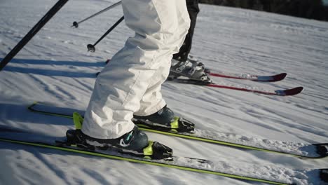 4k slow motion close up tracking side view of skis going downhill at high speed on a sunny winter day in norway