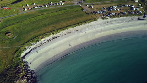 numerous-camper-vans-parked-near-Hov-beach,-Hov-Camping,-Lofoten,-sunny-day