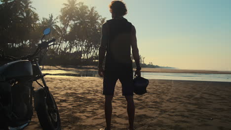 Man on Motorcycle at Tropical Beach Sunrise