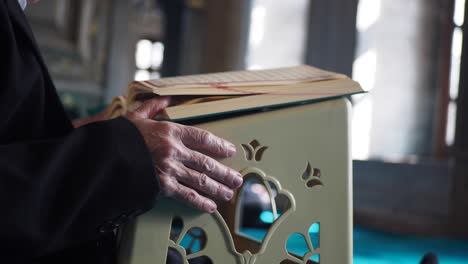 person reading quran in a mosque