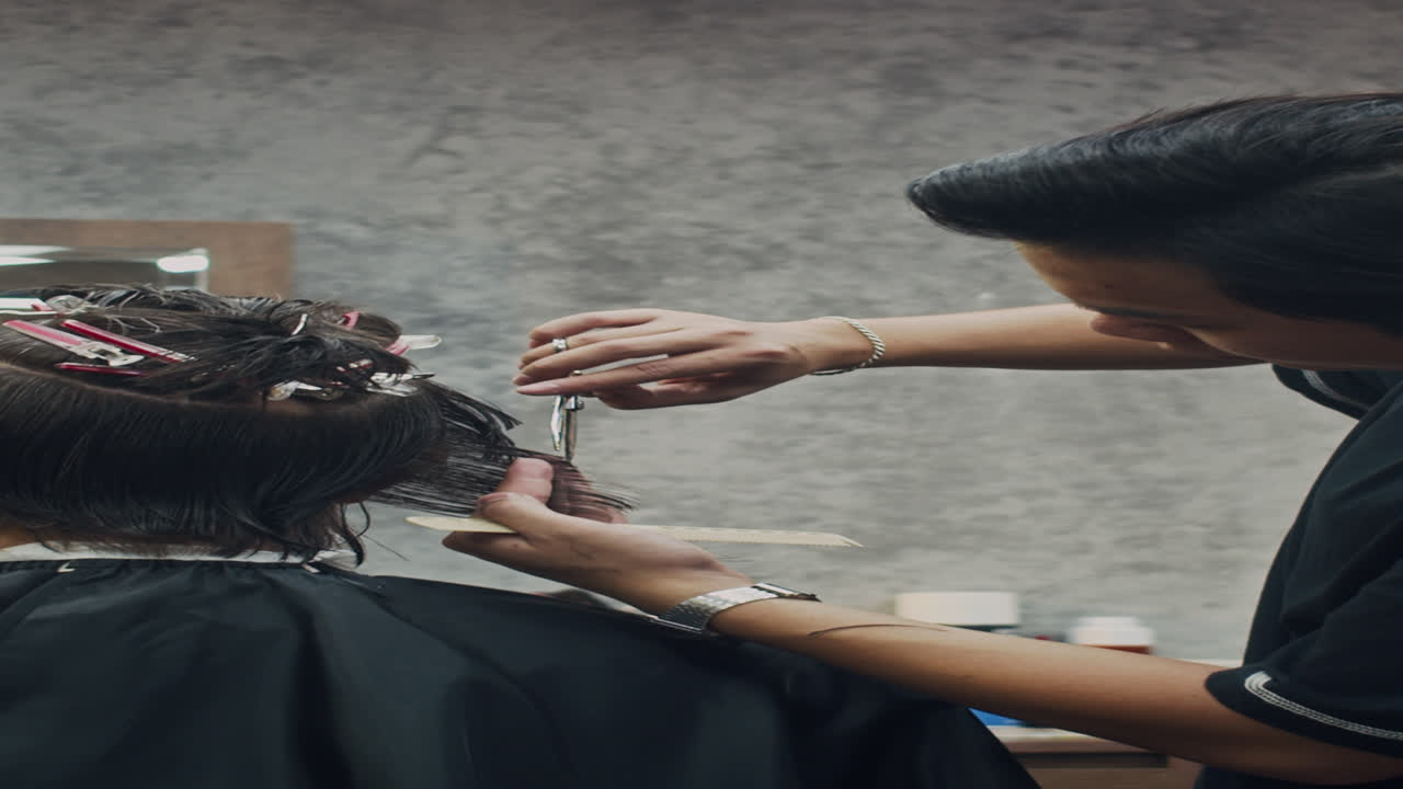 Vertical of Barber Cutting Hair of Male Client with Scissors