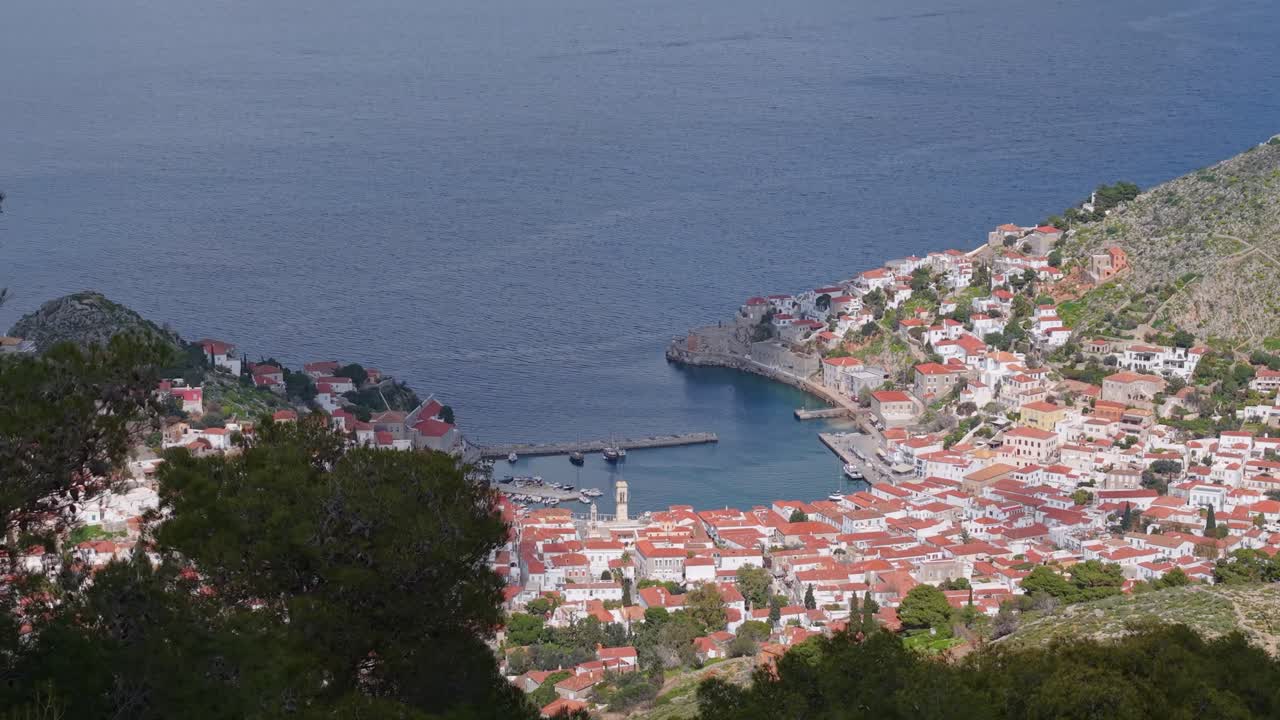 Drone footage reveals the traditional village of Hydra, Greece. Tiled rooftops, narrow alleys, and scenic harbor views unfold in this cinematic aerial perspective.