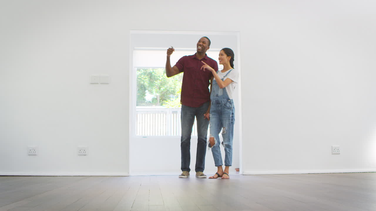 Excited Young Couple Moving Into New Home Together