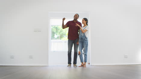 excited young couple moving into new home together