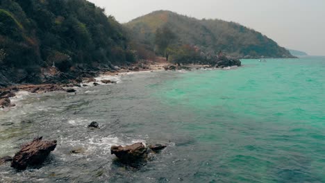 exciting-brown-rocky-coastline-near-green-forestry-hills