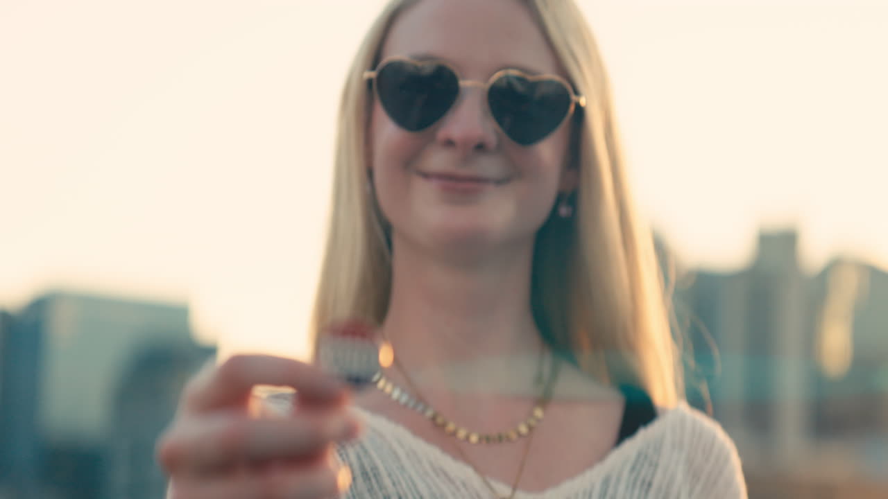 Woman with 'I Voted' badge wearing heart sunglasses
