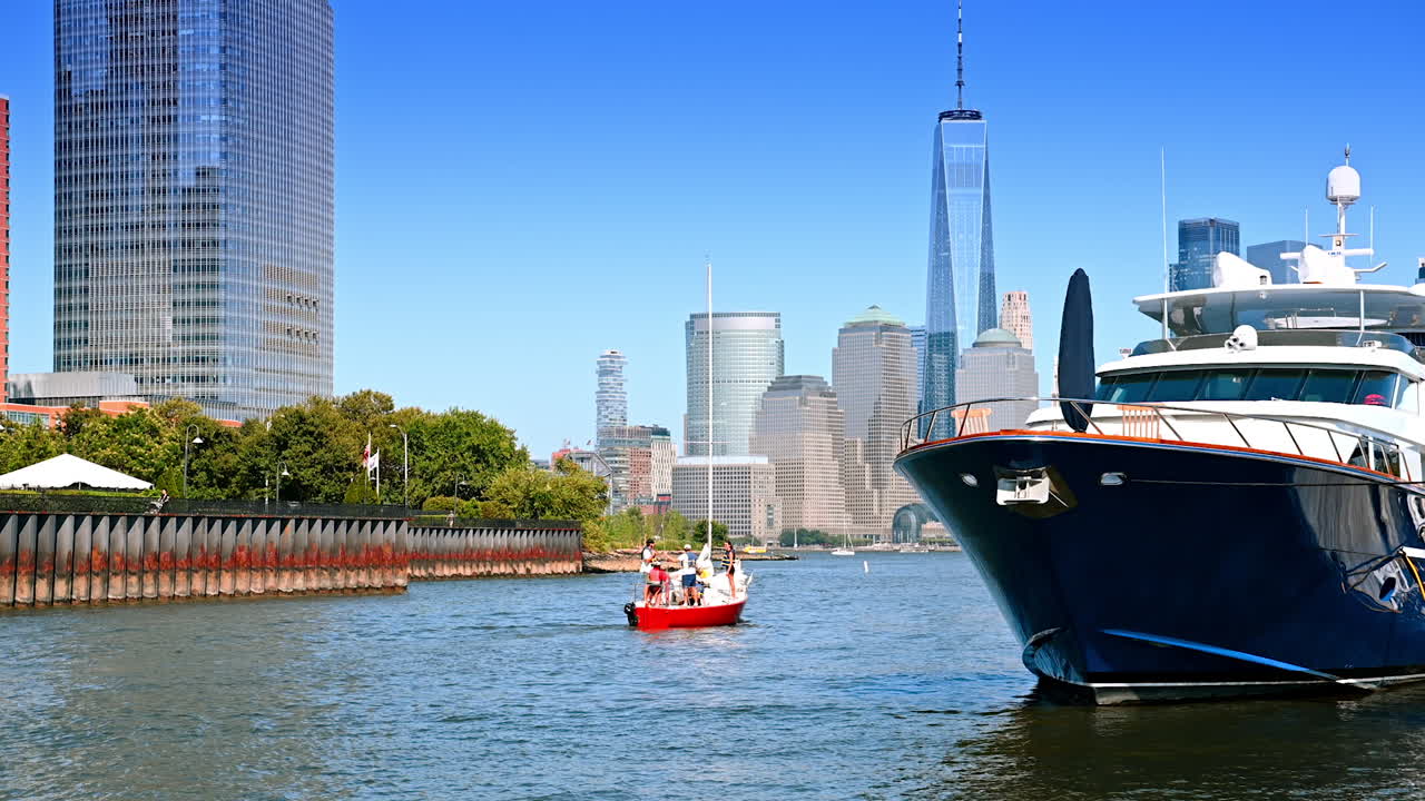 New Jersey, USA, 19 August 2025: Group of people travelling by sailboat from Jersey City quay. Big boat stands on the anchor at the berth. Skyline of Manhattan at backdrop