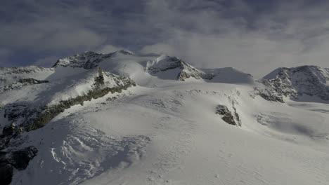 panoramic drone shot of the sunny castore and felik glaciers and castore peak from rifugio quintino sella, after a spring snowstorm has blanketed the landscape