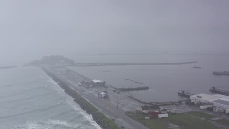 aerial wide panning shot of crescent harbor during a storm in crescent city, california. 4k