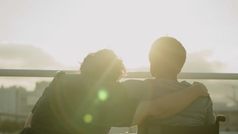 happy couple with disability embracing in background of sunset