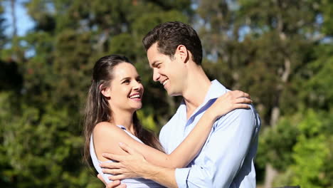 Happy-couple-embracing-in-the-park