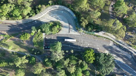 Top-down-drone-shot-of-Bus-driving-into-underground-tunnel