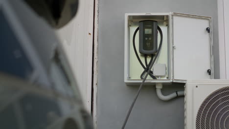 close up of wall mounted home ev car charger station ready for charging