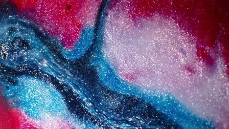 vibrant red, blue, and white substances blending in a sparkling close-up macro shot