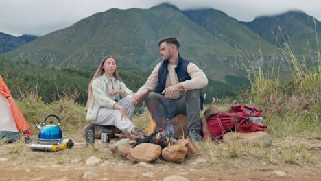 couple, camping and fire with wood