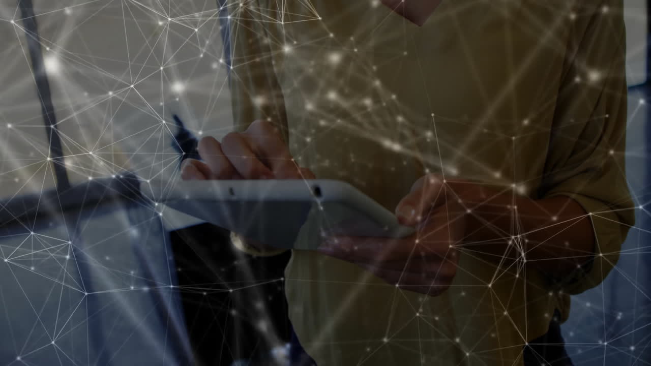 Female professional tapping tablet in tech office, displaying network nodes and lines