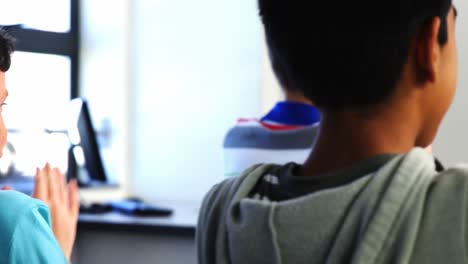 happy students clapping during presentation in classroom